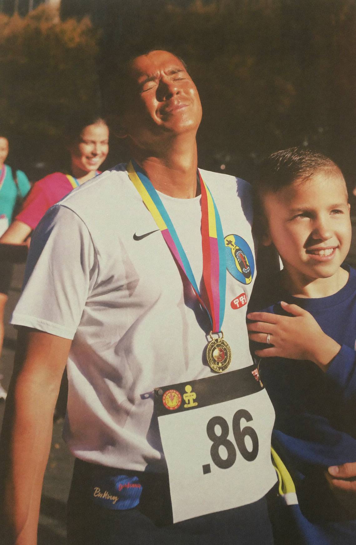 Illustration: a tired runner with a medal, a child at his side, just past the finish